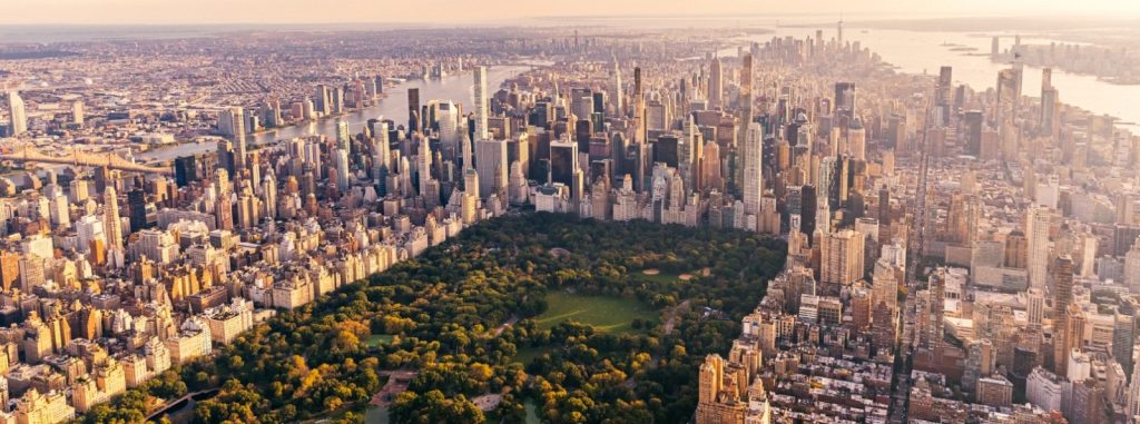 Aerial view of Central Park, Manhattan skyline at sunset.