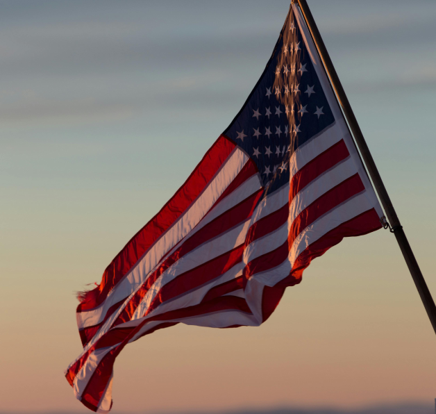 American flag waving at sunset