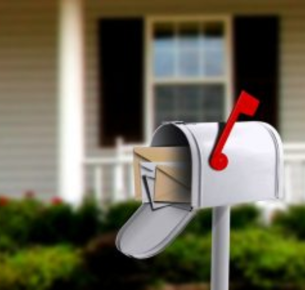 Open mailbox with letters, house in background.